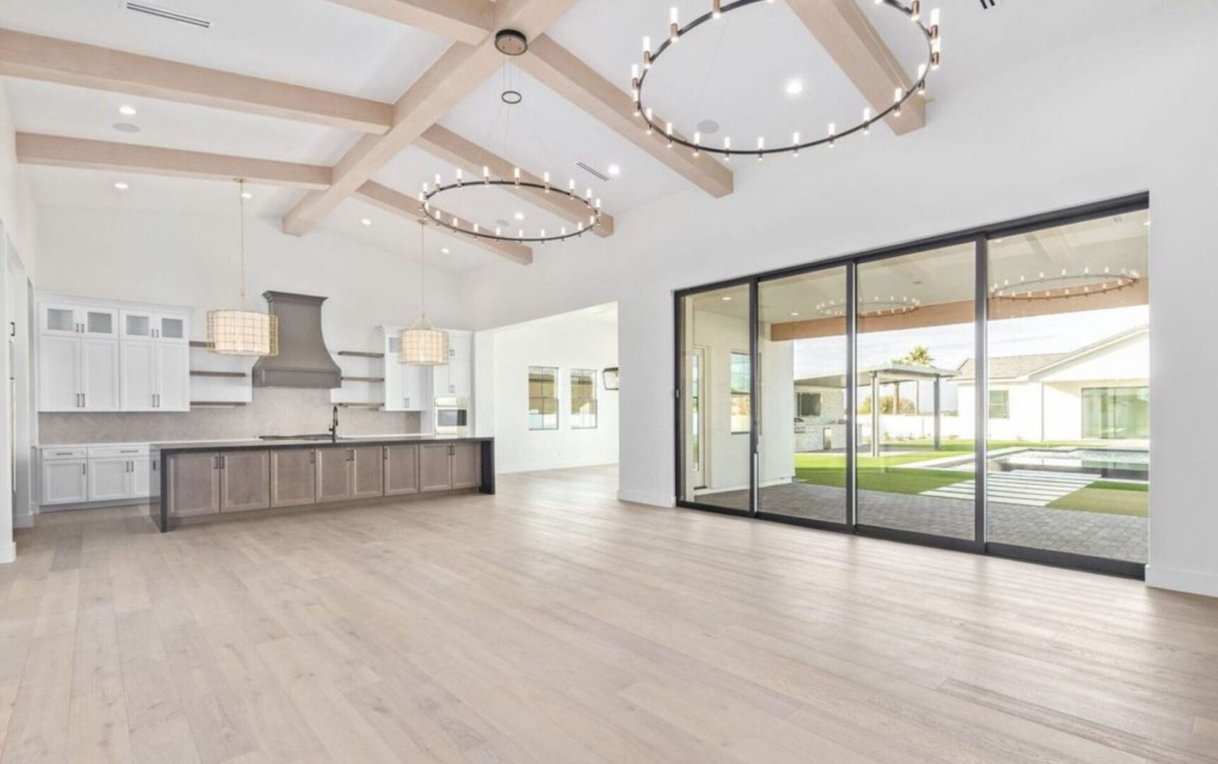 A large open kitchen with wood floors and white walls.